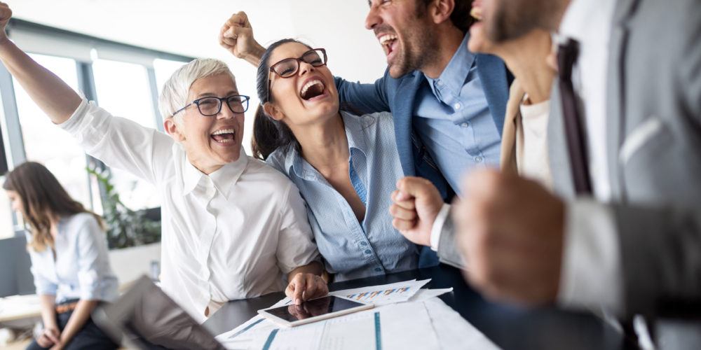 Business team celebrating a good job in the modern office